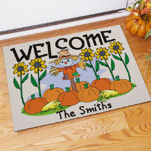 Scarecrow Welcome Doormat featuring sunflowers, pumpkins and personalized with your name for Halloween or Thanksgiving fun.