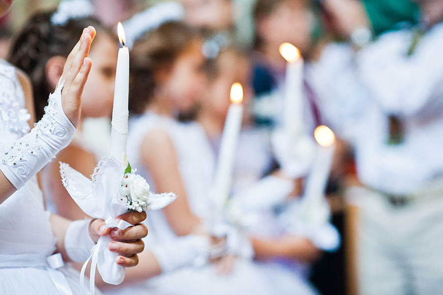 girls holding communion candles